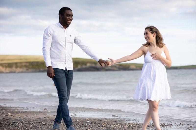 Couple walking hand in hand along a beach