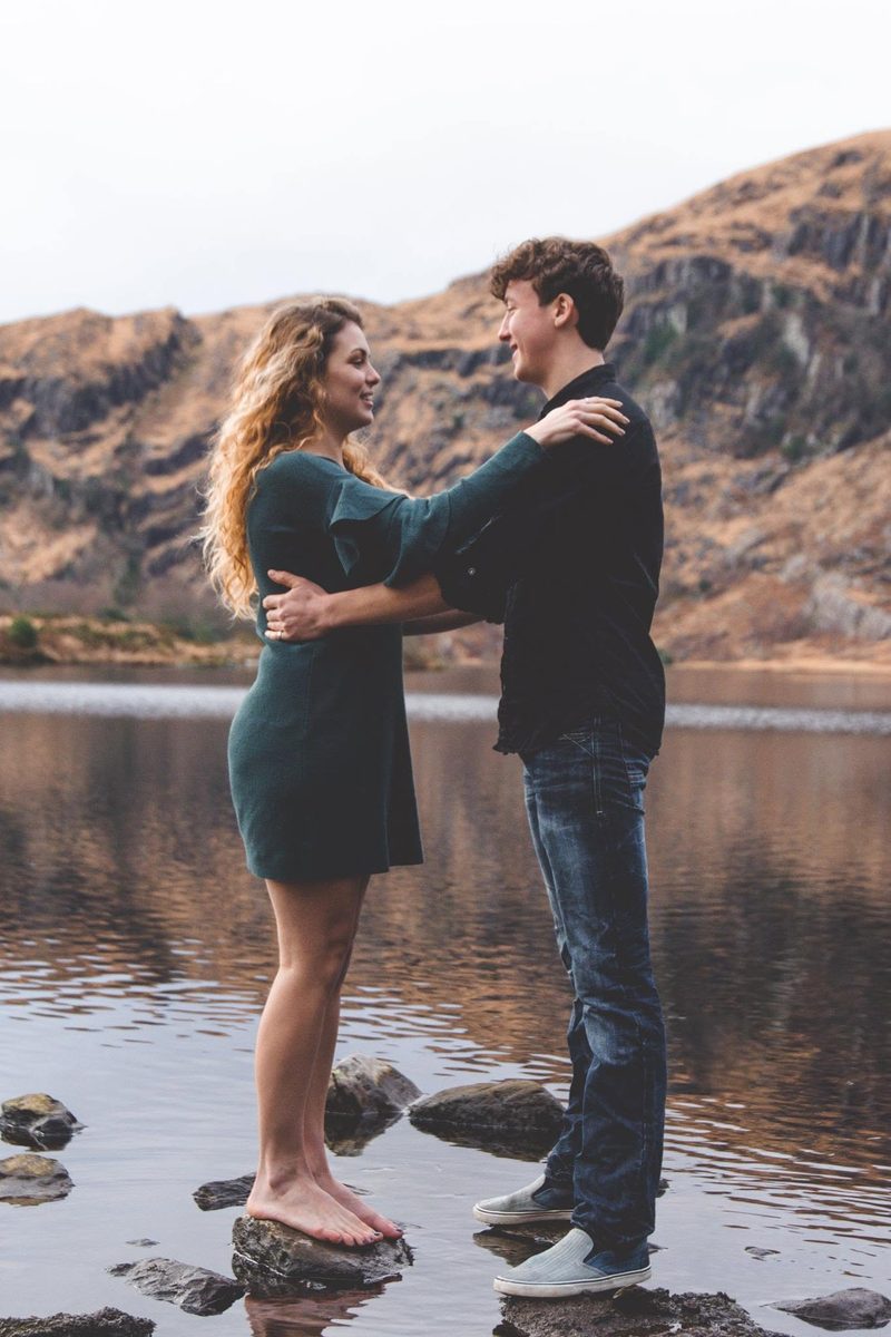 Couple embracing barefoot in a mountain lake