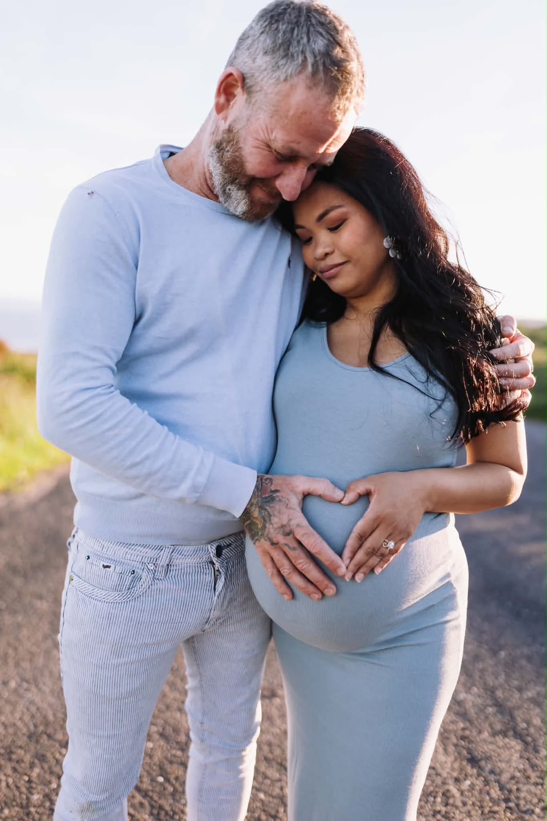 Expecting couple in a warm golden-hour portrait