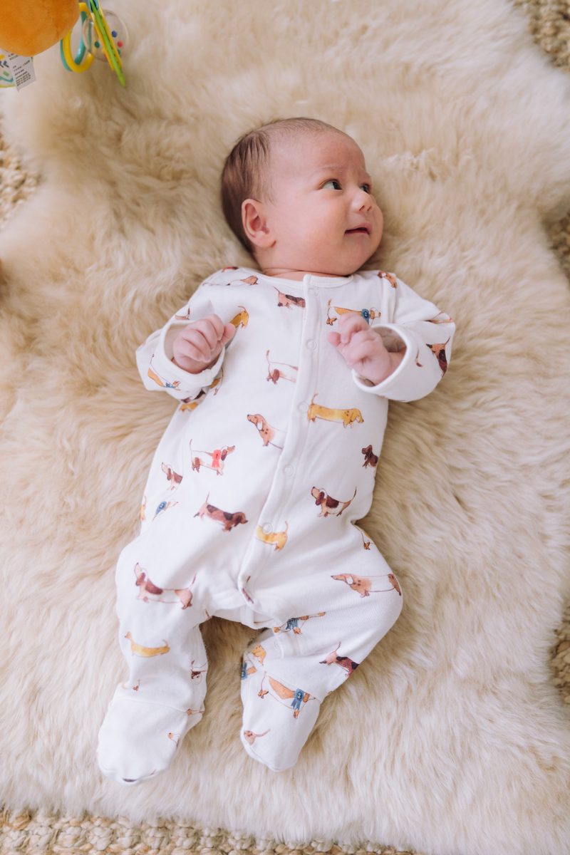 Newborn baby lying on a sheepskin rug